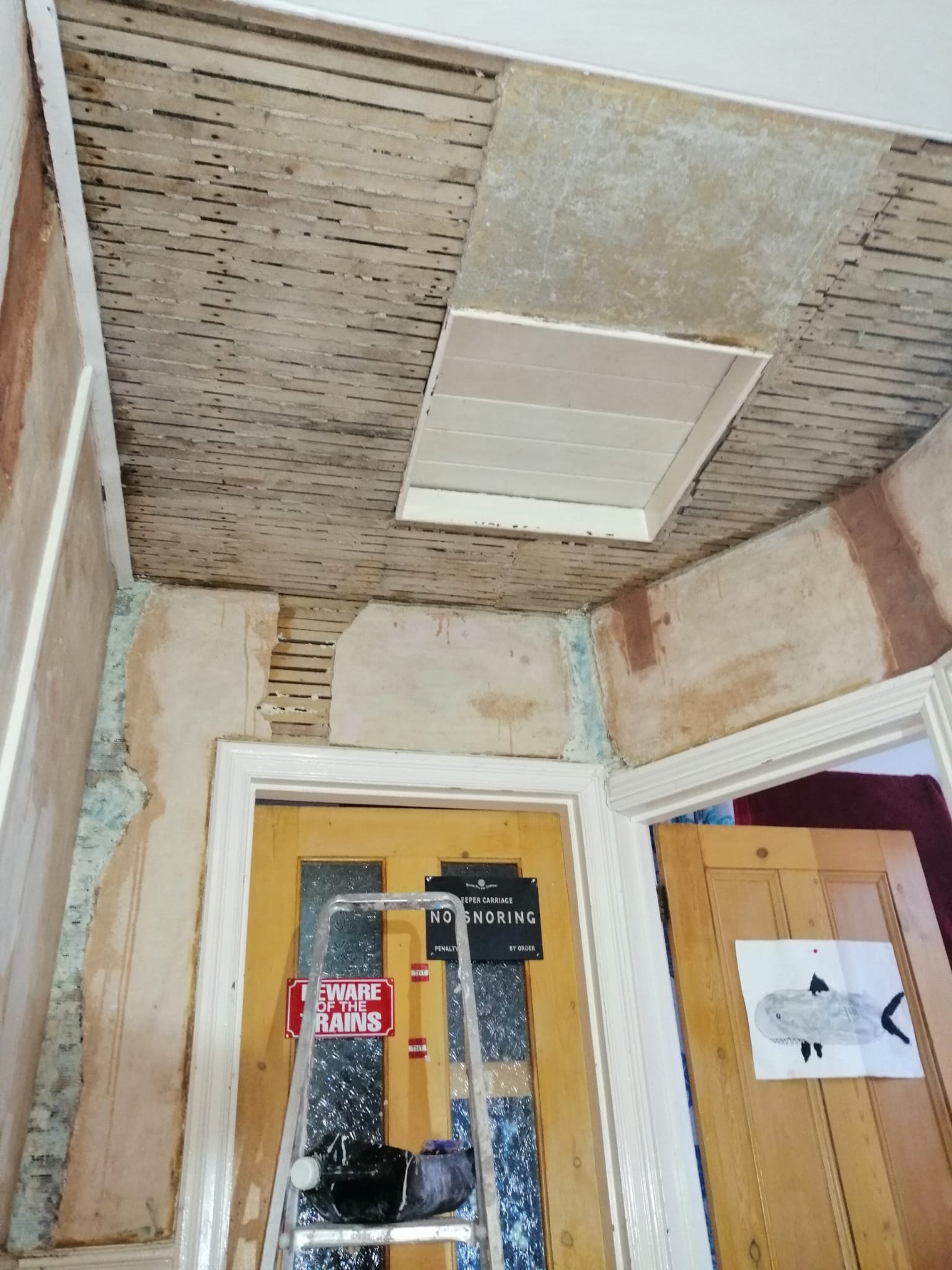 Home interior with worn away plaster in need of paint.